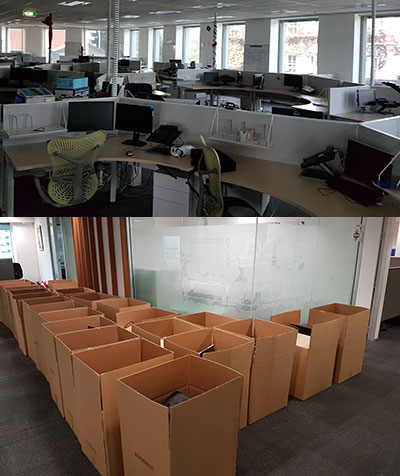 Office workstations and rows of boxes photographed during a WEI decommissioning job
