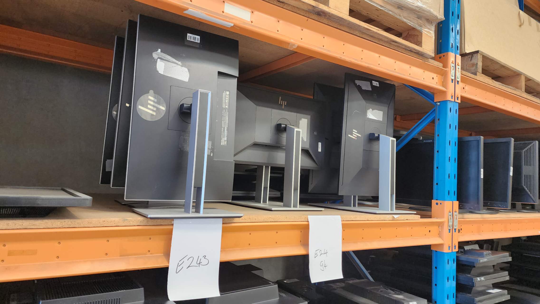 HP business monitors stored on warehouse shelving