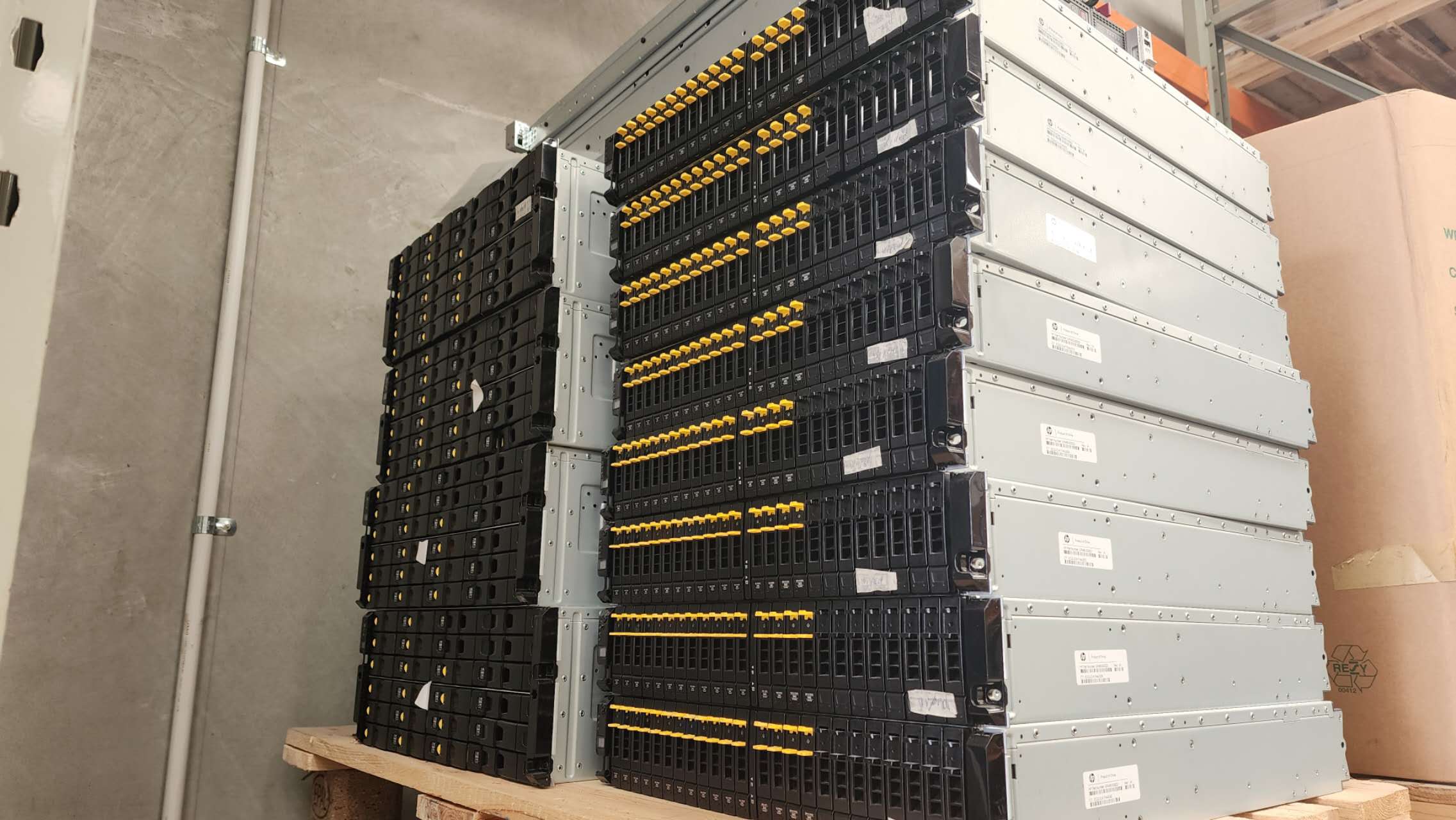Stacks of rackmount server and storage equipment on a warehouse pallet